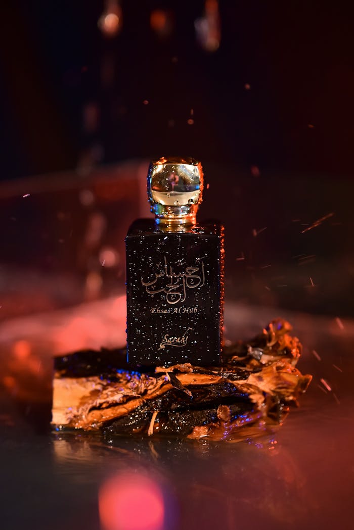 Mastering the First Impression: Your intriguing post title goes here Luxurious perfume bottle with wood base in a dramatic, warm setting.