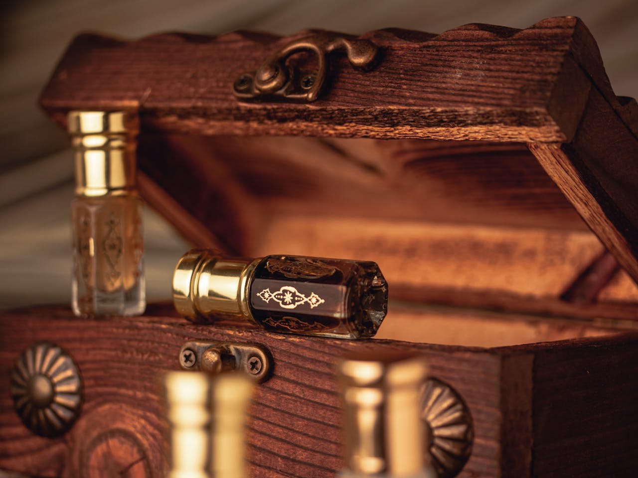 The Art of Drawing Readers In: Your attractive post title goes here Close-up of antique perfume bottles in an open rustic wooden box, showcasing elegance and luxury.